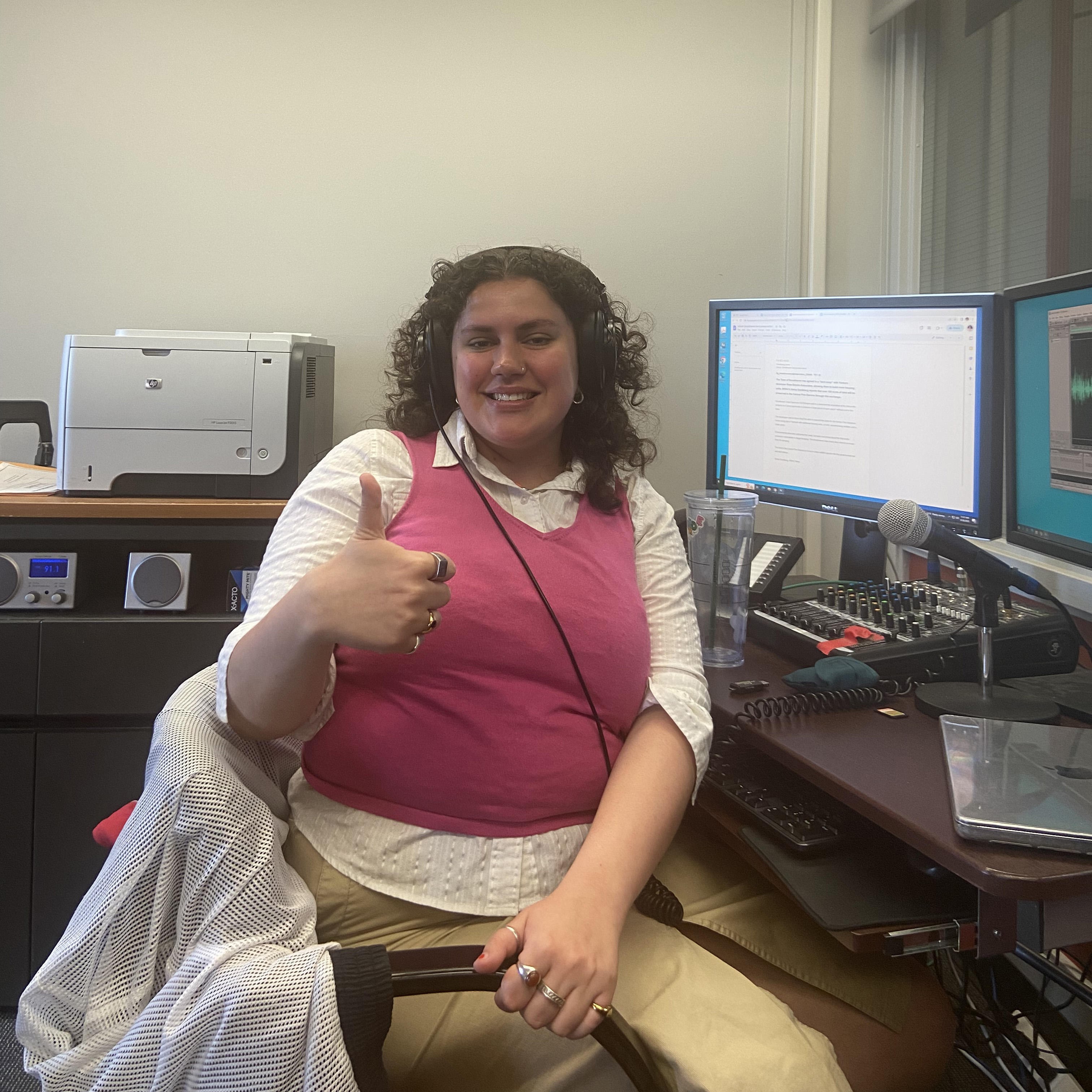 Xenia Gonikberg gives a thumbs up from her desk in the WSHU public radio bureau on campus