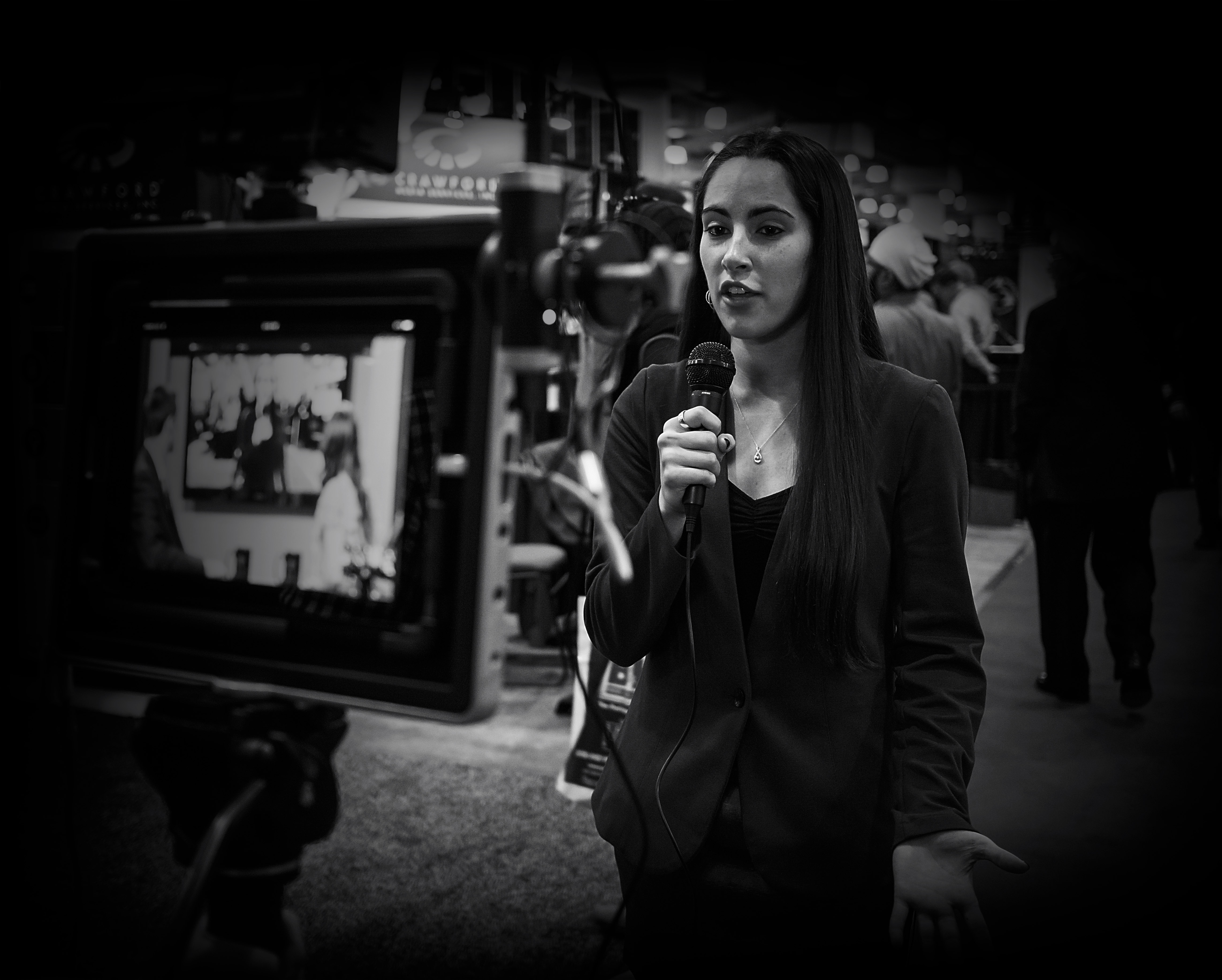 female student speaks into a microphone in front of a TV camera